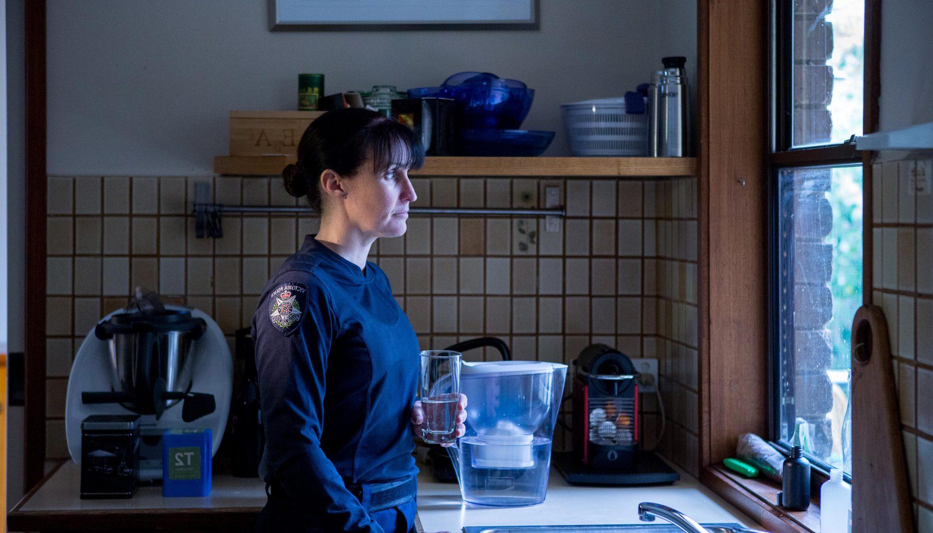 Police officer looking out the kitchen window